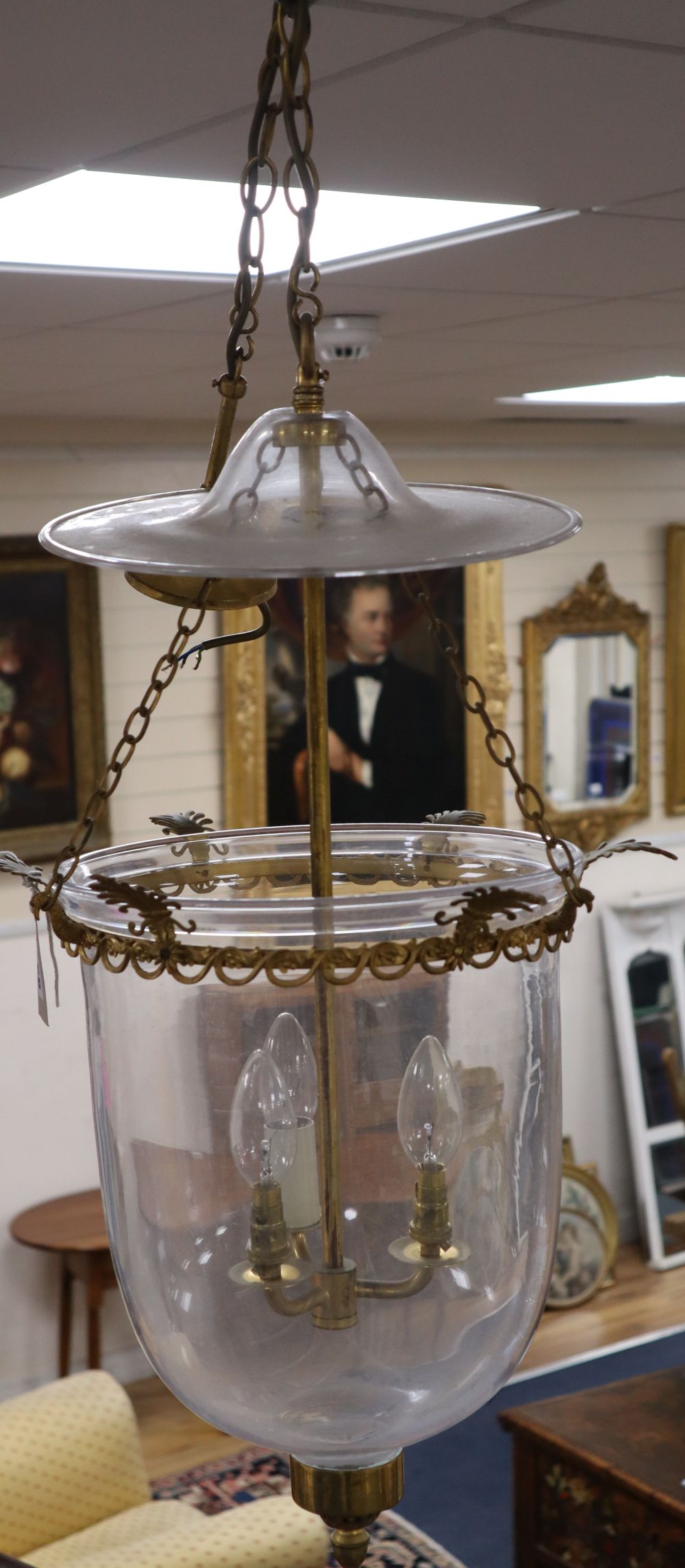 A pair of three light hall lanterns, cast with anthemions, height 63cm